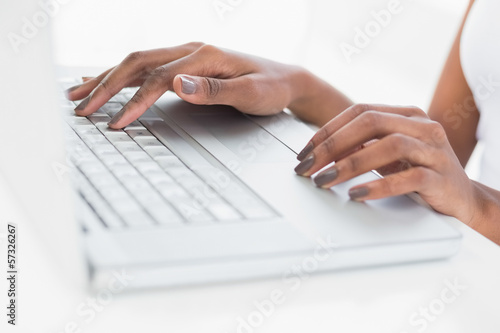 Close up on womans hands using her laptop © lightwavemedia