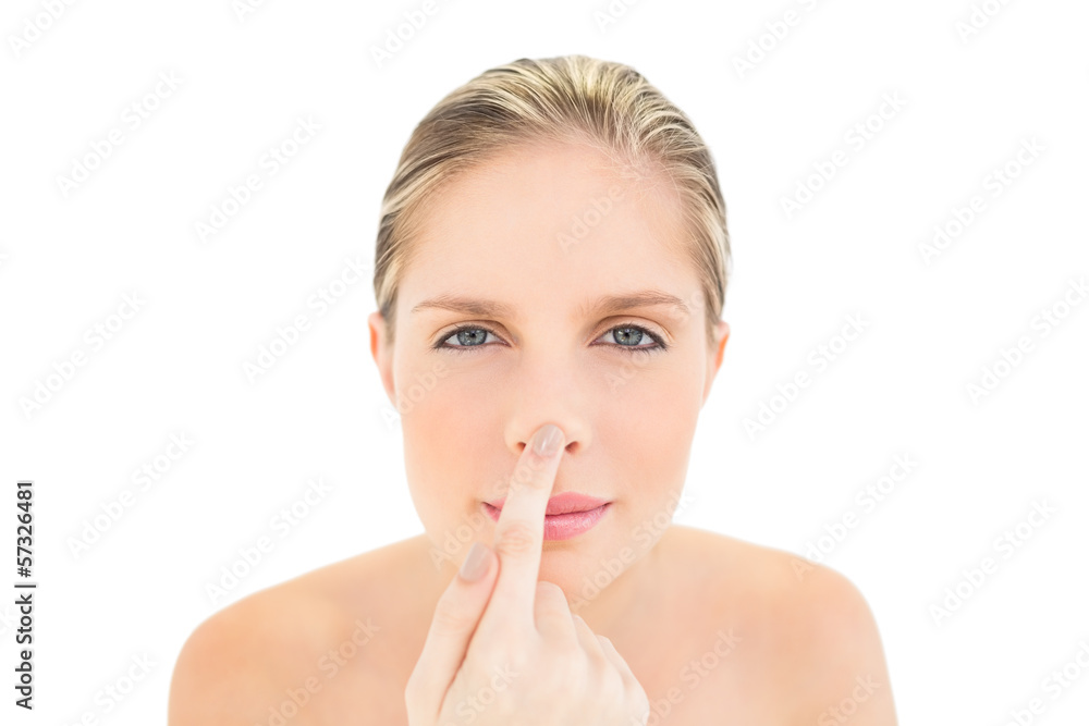 Peaceful fresh blonde woman touching her nose Peaceful fresh blonde woman touching her nose