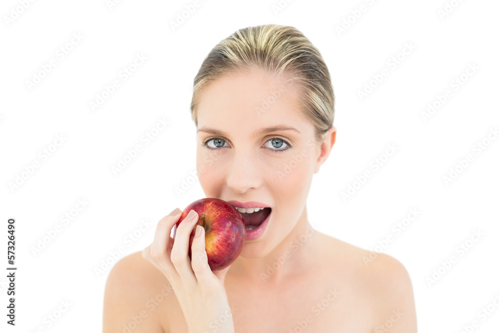 Beautiful fresh blonde woman eating a red apple Beautiful fresh blonde woman eating a red apple
