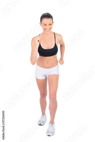 Smiling woman in sportswear preparing for race