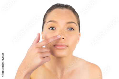 Woman pointing on her nose