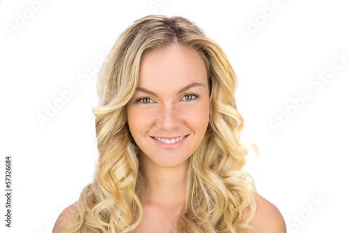 Smiling curly haired blonde posing