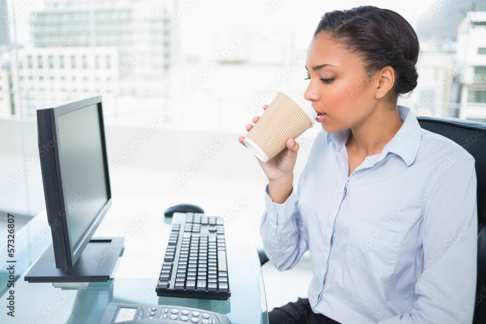 Relaxed young dark haired businesswoman drinking coffee Relaxed young dark haired businesswoman drinking coffee