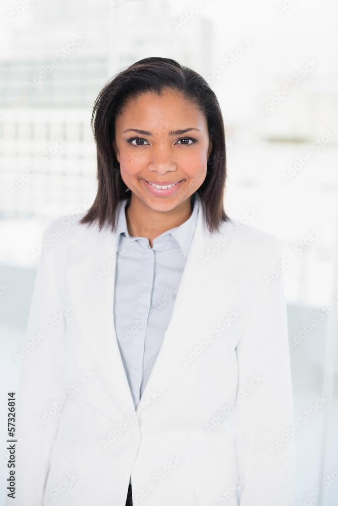 Happy young dark haired businesswoman posing looking at camera Happy young dark haired businesswoman posing looking at camera