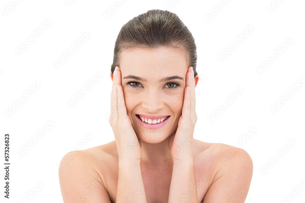 Happy woman touching her face and looking at camera Happy woman touching her face and looking at camera