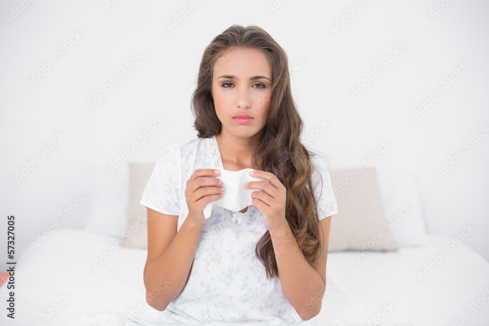 Sad pretty brunette holding a tissue Sad pretty brunette holding a tissue