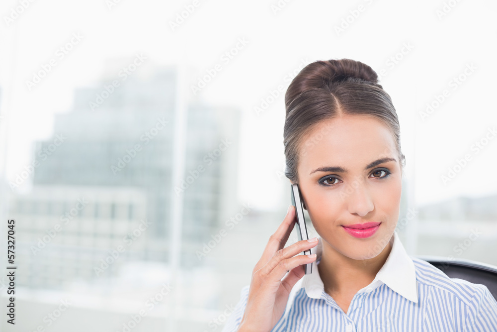 Smiling brunette businesswoman phoning with smartphone Smiling brunette businesswoman phoning with smartphone