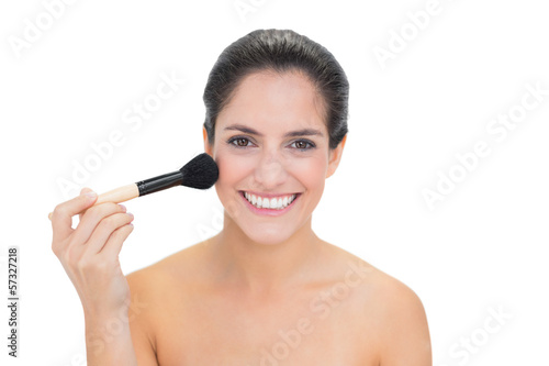 Cheerful smiling bare brunette holding brush