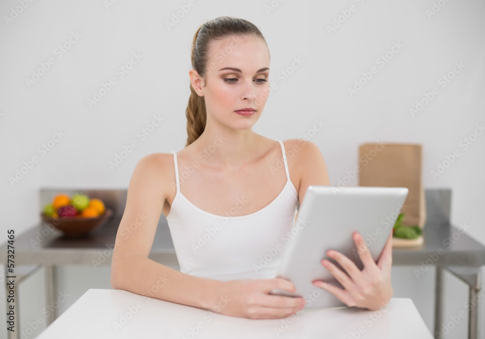 Serious young woman using her tablet pc Serious young woman using her tablet pc