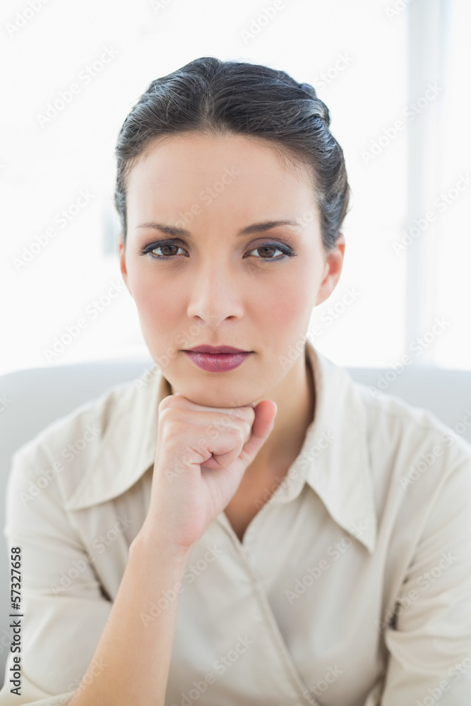 Thoughtful stylish brunette businesswoman posing looking at came Thoughtful stylish brunette businesswoman posing looking at came