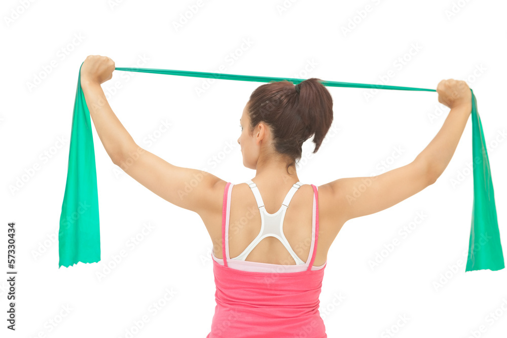 Rear view of sporty brunette stretching with resistance band Rear view of sporty brunette stretching with resistance band