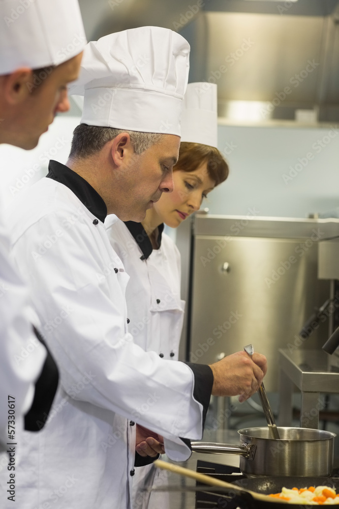 Head chef inspecting his students pot