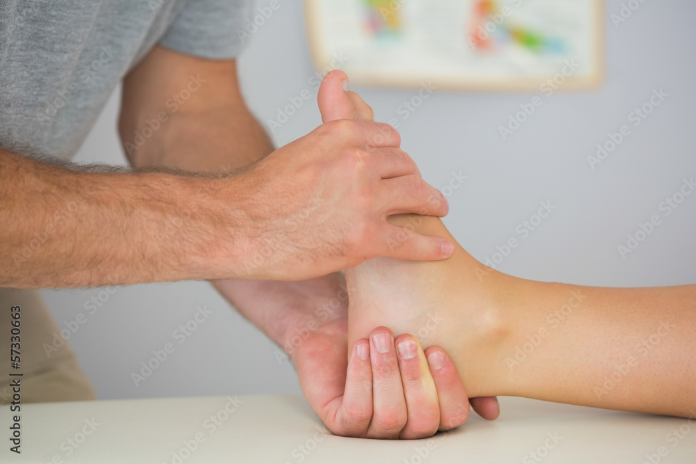 Fototapeta premium Physiotherapist controlling patients foot