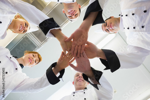 Canvas Print Chefs joining hands in a circle