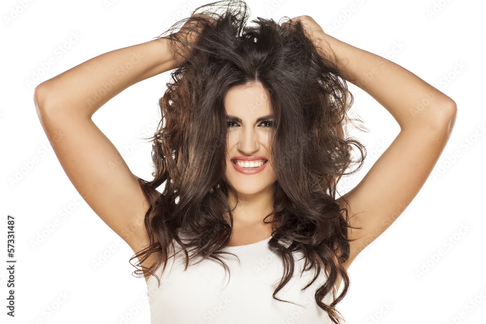Fototapeta premium portrait of a beautiful girl who is having fun with her hair