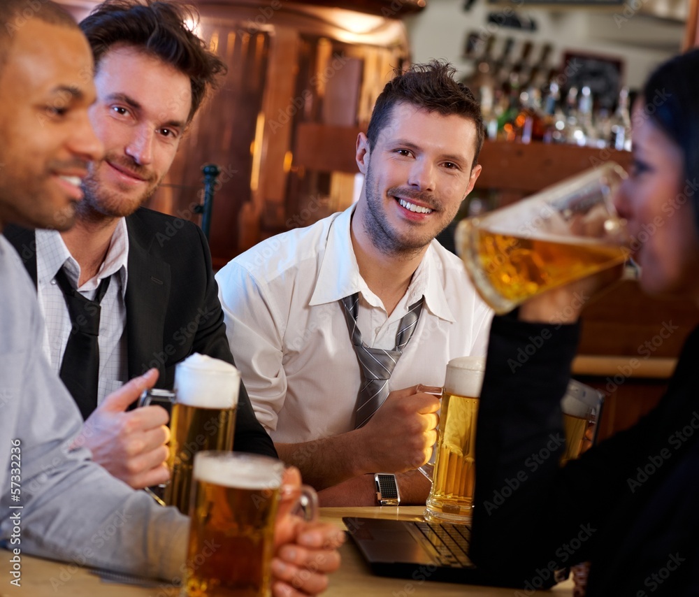 Group of friends drinking beer at pub