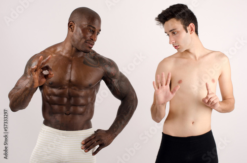 Two man, black and white, bodybuilder and a slim guy