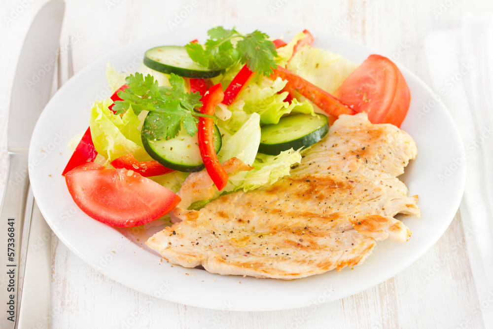 grilled turkey with salad on plate