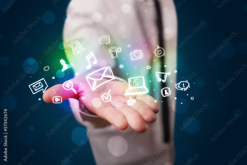 Obraz premium Young businessman presenting colorful glowing social media icons