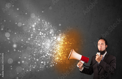 Guy shouting into megaphone and glowing energy particles explode