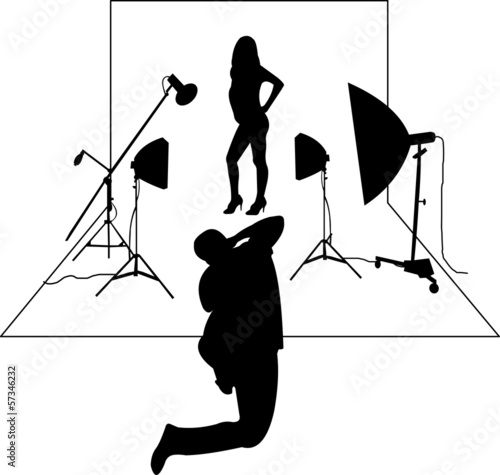 Model posing in studio in front of the photographer layered