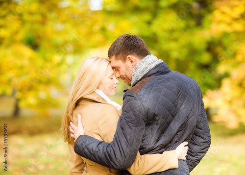 romantic couple kissing in the autumn park