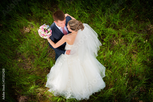 Groom and  bride on green glade photo