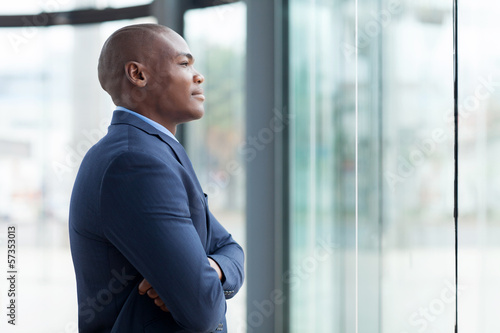 african businessman with arms crossed