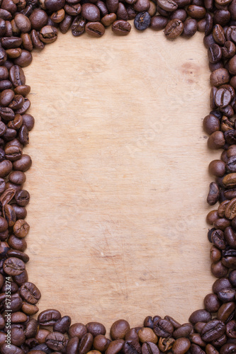 Coffee beans frame on a wooden background © czarny_bez