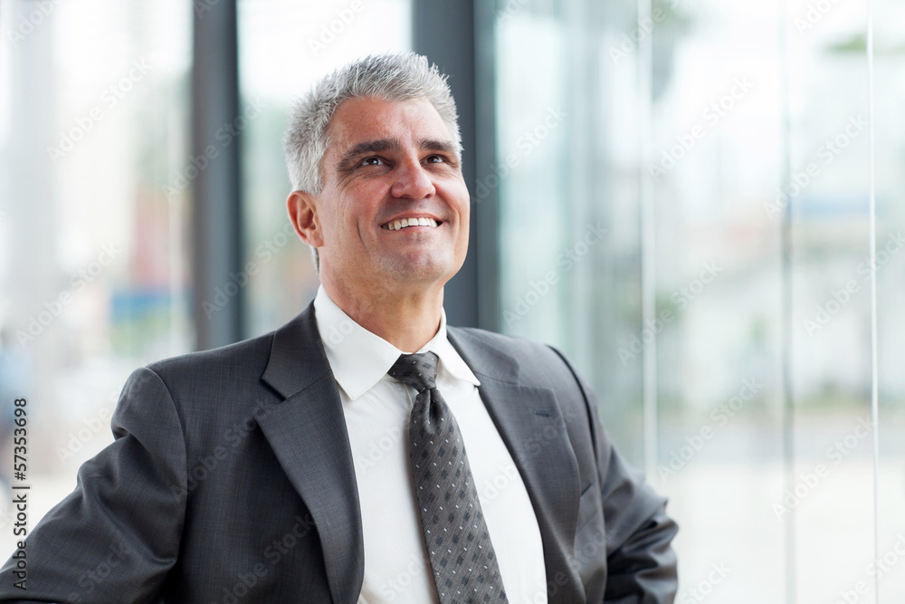 middle aged businessman looking up middle aged businessman looking up