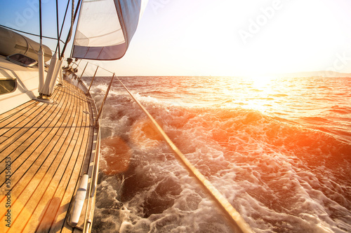 Sailing yacht against sunset. Luxury yachts.