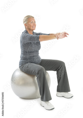 Senior Woman Exercising On Fitness Ball