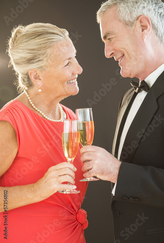 Smiling Couple Toasting Champagne Flutes
