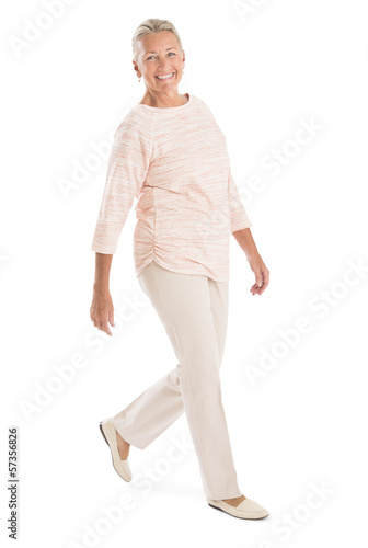 Senior Woman Walking Against White Background