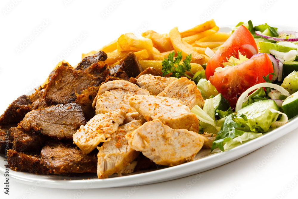 Grilled meat with French fries and vegetables Grilled meat with French fries and vegetables