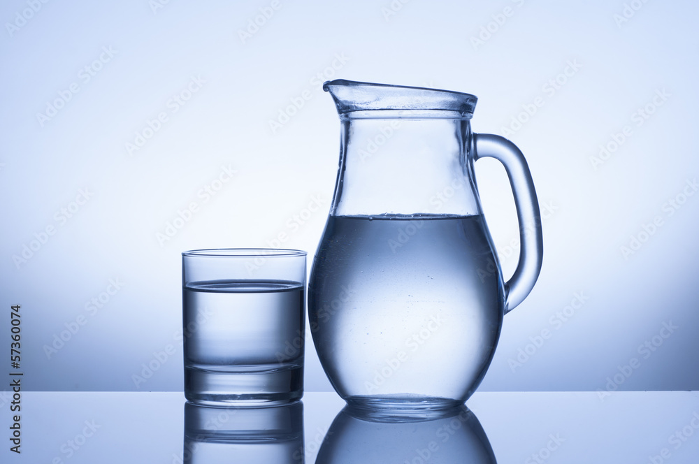 water glass and jug on blue background water glass and jug on blue background