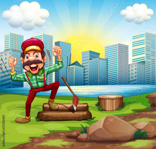 A man chopping the woods at the riverbank across the buildings