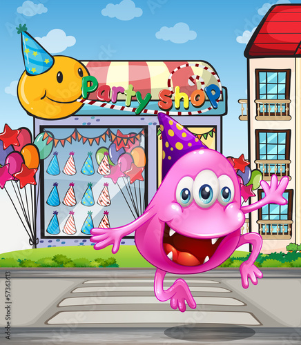 A happy beanie monster jumping in front of the party shop