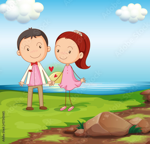 A couple at the riverbank near the rocks