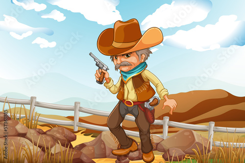 A man with a gun standing near the rocks