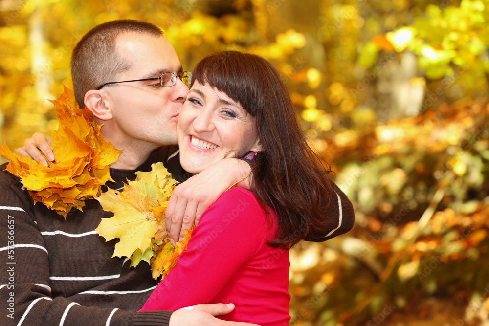 Fototapeta premium Portrait of young man kissing his girlfriend