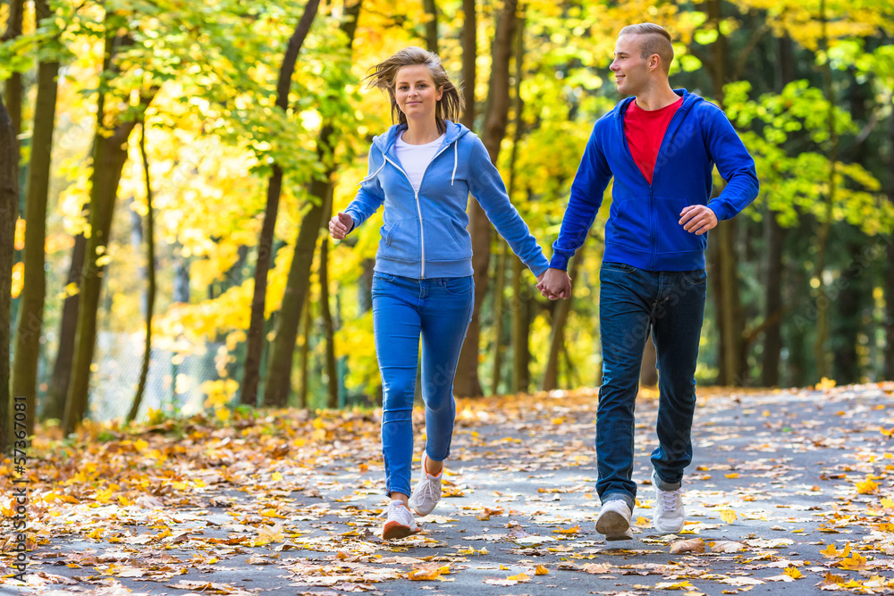 Urban leisure - woman and man running in park Urban leisure - woman and man running in park