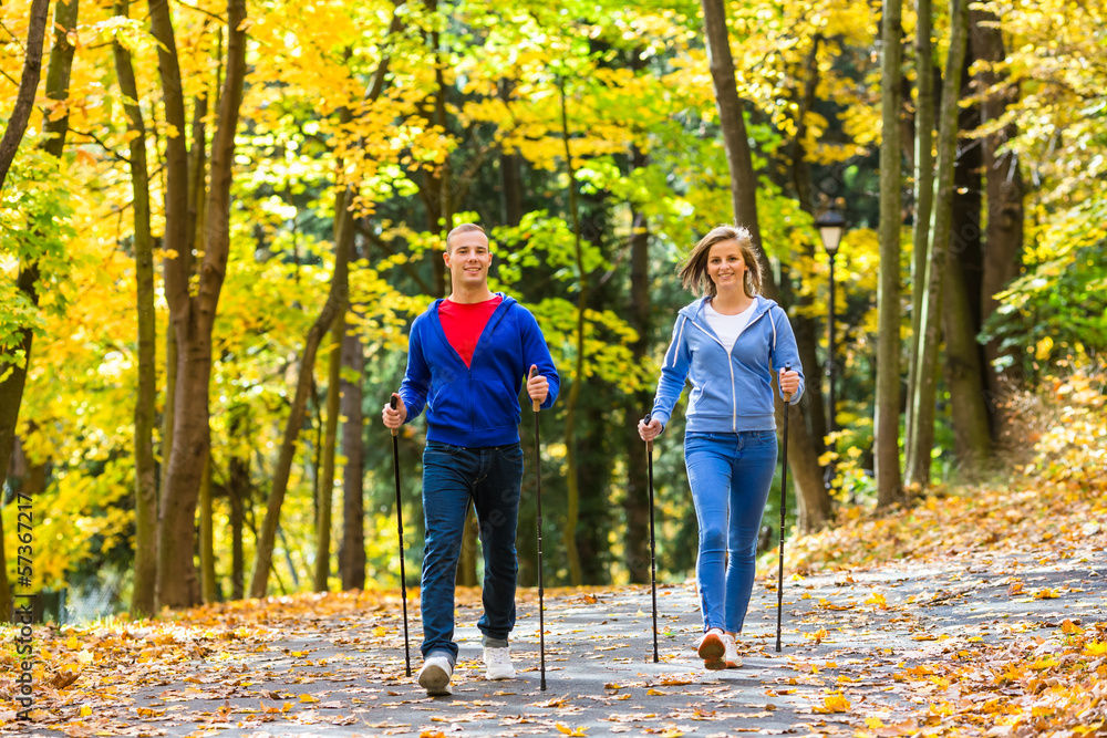Nordic walking - active people working out outdoor Nordic walking - active people working out outdoor
