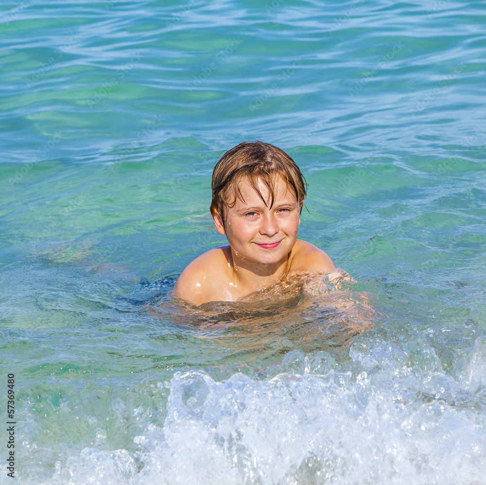 boy enjoys the clear water in the ocean
