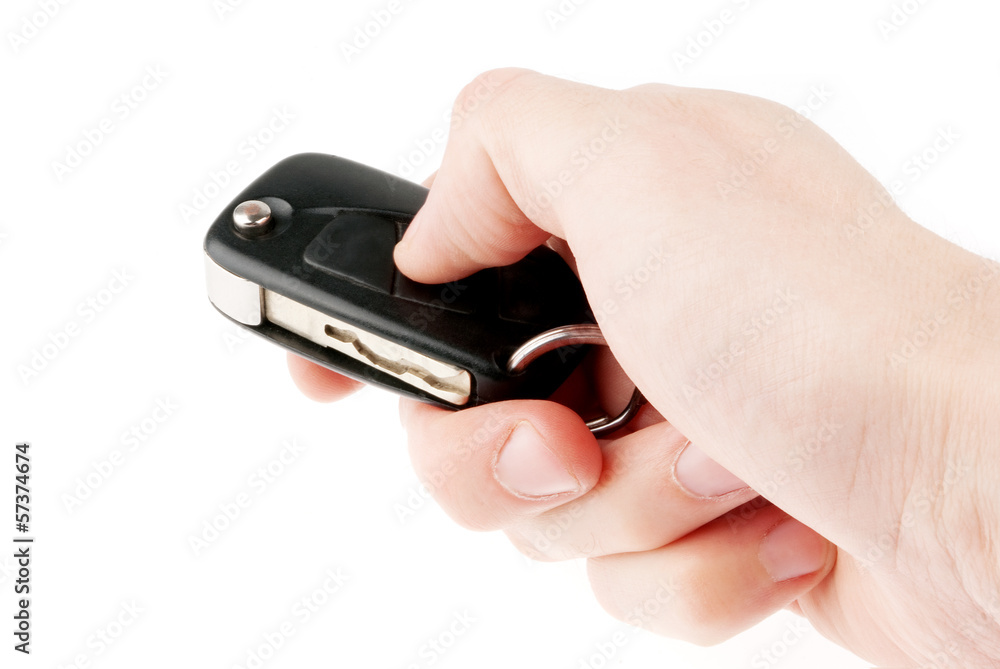 Hand holding car keys isolated on white background