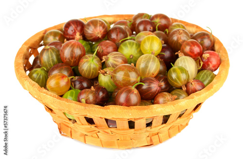 Fresh gooseberries in wicker basket isolated on white