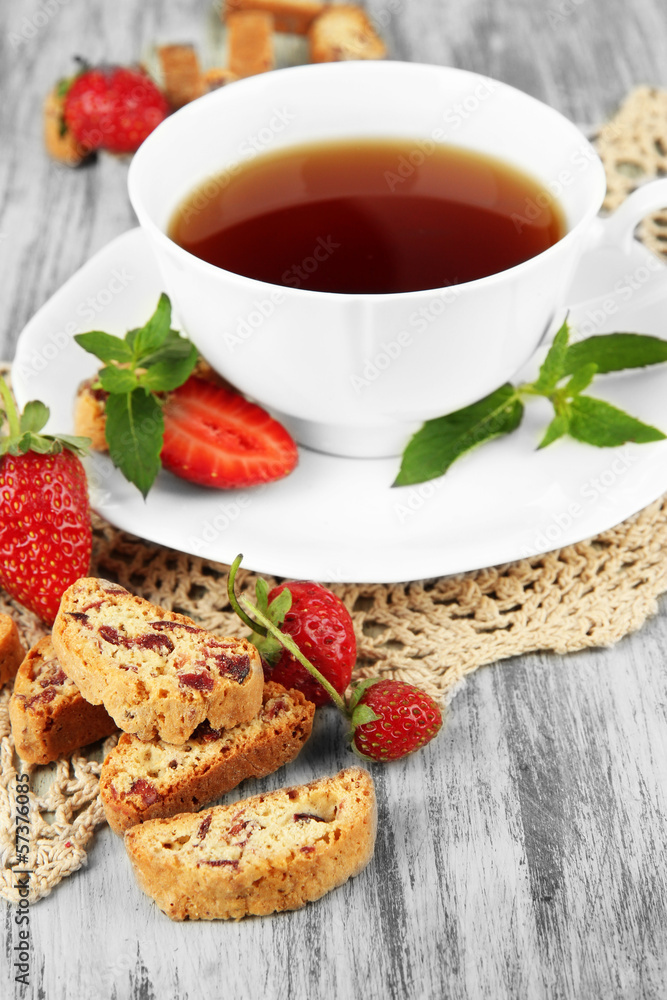 Cup of tea with cookies and strawberries on table close-up Cup of tea with cookies and strawberries on table close-up