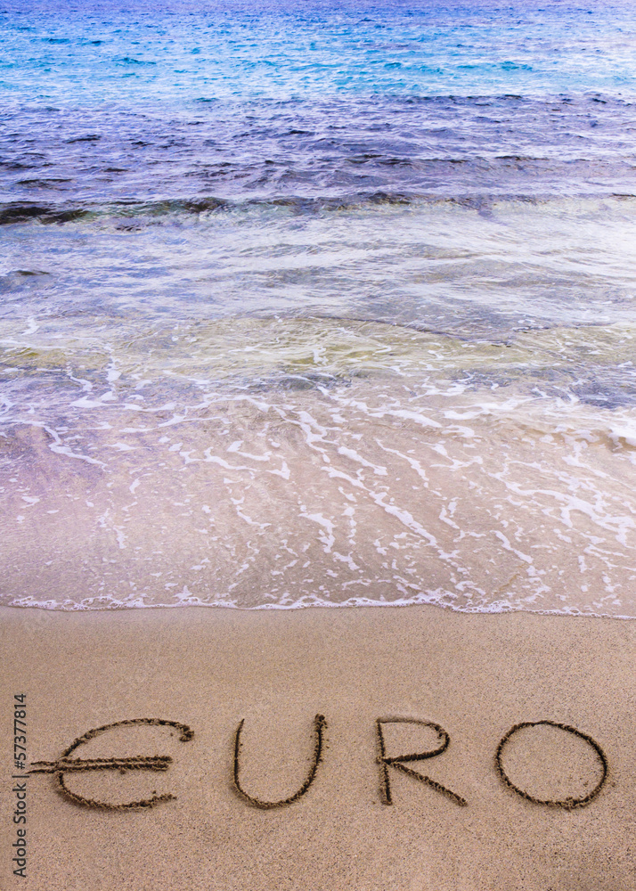Fototapeta premium Euro word written in the sand on a beach