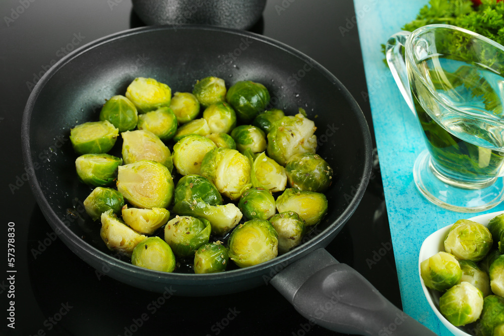 Fresh brussels sprouts in pan on cooking surface close-up Fresh brussels sprouts in pan on cooking surface close-up