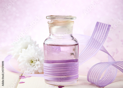 Glass bottles with color essence, on light background